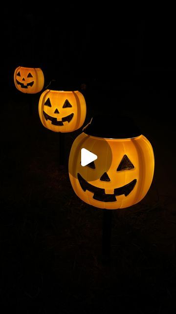 Jenna Gibbs on Instagram: "🎃 DIY Solar Jack-O’-Lanterns! 🎃 Level up your outdoor Halloween decor with this easy & affordable DIY! Grab some bucket pumpkins from @walmart & solar-powered path lights from @loweshomeimprovement to create your own glowing jack-o’-lanterns! I painted over the face with acrylic black paint to make sure the silhouette would really pop! Also, be sure to hot glue the underside of the lights to the pumpkin so that they don’t slide down 🧡  ✨ Comment “PUMPKIN” and I’ll send you the links to make your own!  Inspo: @kelsimsavage   #halloweendecor #halloweenoutdoordecor #halloweendiy #halloweenspirit #jackolanterns #jackolantern #halloweenpumpkin #halloweenpumpkins #diyhalloween #diyhalloweendecorations #solarlights #halloweenlights" Light Up Pumpkins Outdoor Diy, Pumpkin Lights Ideas, Pumpkin Solar Lights Diy, Diy Outdoor Pumpkins, Pumpkin Lanterns Diy, Halloween Light Decorations, Jackolantern Ideas, Halloween Solar Lights, Halloween Lighting Outdoor