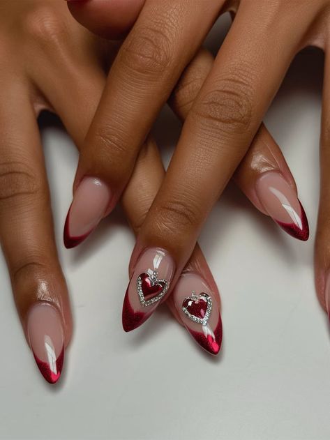 A romantic red French tip manicure on almond-shaped nails, with heart accents and embedded rhinestones. This playful yet stylish design is perfect for date nights and special occasions. Red French Glazed Nails, French Manicure With Hearts, Tips On Almond Nails, French Tips On Almond Nails, French Glazed Nails, Manicure With Hearts, Red French Tips, Glazed Nails, Tip Manicure