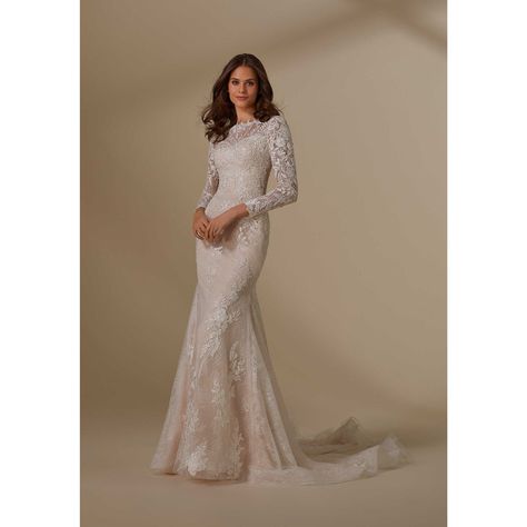 Luxe Lace Takes Center Stage On Our Liana Wedding Dress. The Romantic Chantilly Lace Fit And Flare Features An Illusion, Beatuiful Neckline Leading To Modest Long Sleeves With Frosted, Embroidered Lace Appliqus That Cascade Down The Gown. The Tulle Overskirt With Embroidered Lace Appliqus Creates A Fuller Silhouette, Giving You A Beautiful Transitional Look. Shown In Ivory/Champagne/Honey. Overskirt Sold Separately. Wedding Gown Long Sleeve, High Neck Lace Wedding Dress, Long Sleeve Wedding Gown, Tulle Overskirt, Princess Wedding Gown, School Dance Dresses, Modest Wedding Gowns, Long Sleeve Wedding Dress Lace, Winter Wedding Dress