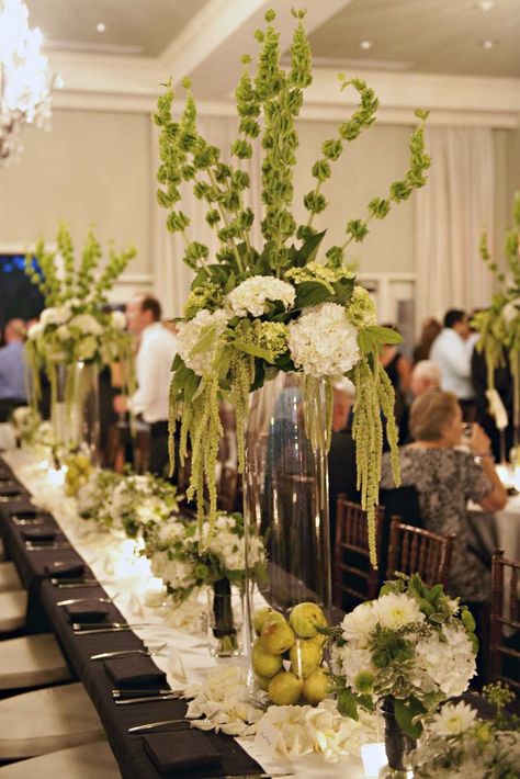 green and white arrangements of hydrangea, bells of Ireland, hanging amaranthus Hanging Amaranthus, Tall Flower Arrangements, Bells Of Ireland, Green Centerpieces, Wedding Reception Flowers, Wedding Event Decor, Ireland Wedding, Wedding Favors Fall, Tall Centerpieces