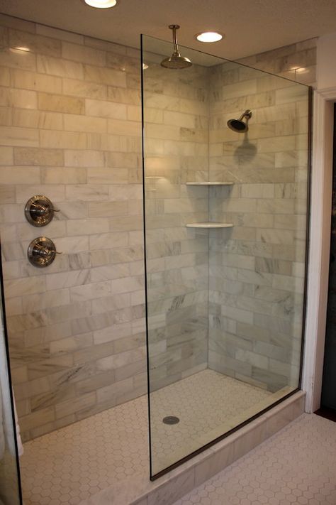 Jennifer Brown - Amazing glass walk-in shower features carrera marble tiles shower surround, rain shower head, corner shower shelves and white hex tile shower floor. Makeover Kamar Mandi, Small Bathroom With Shower, Walk In Shower Designs, Master Shower, Decor Baie, Master Bath Remodel, Bathroom Shower Tile, Bathroom Remodel Designs, Bathroom Remodel Shower