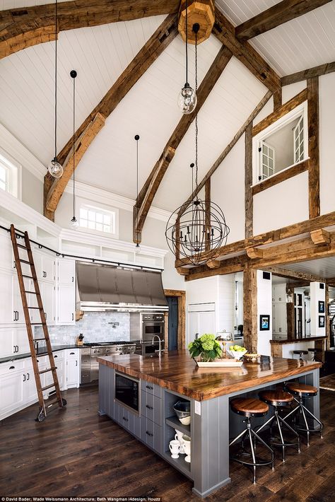 Stunning: This American property was singled out for its large kitchen island work space and quirky ladders used to reach extra storage. This Midwest Lake House renovation was completed in 2015 and cost more than $2,000,000 (£1.58million). The owner has a lifelong passion for rowing and tasked the architects with designing a lake residence that would be reflective of classic American boathouse style Interior Design Per La Casa, Large Kitchen Island, Cottage Kitchens, Hus Inspiration, Interior Design Magazine, The Ceiling, Farmhouse Style House, Large Kitchen, Style At Home