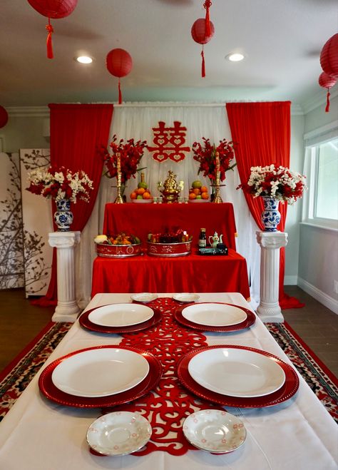 Vietnamese tea ceremony wedding set up. Color scheme is a combination of lucky beight red, white and gold accents. The ceiling has paper lanterns hung from fishing wires giving it a floating effect. Vietnamese Wedding Decorations Tea Ceremony, Vietnamese Wedding Ceremony, Vietnamese Party Decorations, Mexican Vietnamese Wedding, Traditional Chinese Tea Ceremony, Vietnamese Wedding Reception, Vietnamese Tea Ceremony Decor, Viet Tea Ceremony, Vietnamese Engagement Party