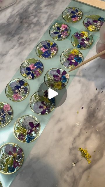 Zoe Ray Tracey on Instagram: "AVAILABLE FRIDAY!
Each one slightly different and unique🫶

#resin #resinart #resinjewelry #resinflowers #pressedflowers #flowerpreservation #jewelry #handmade #handmadejewelry #flowers #flowerjewelry #flowerart #nature #natureart #naturejewelry #botanical #botanicaljewelry #botanicalart #etsy #shopsmall #michiganmade #michiganmade #slowmade #shoplocal" Diy Resin Flowers, How To Make Resin Jewelry, Flower Resin Jewelry, Mosaic Art Projects, Resin Jewelry Diy, Resin Jewelry Making, Epoxy Resin Crafts, Stone Wrapping, Botanical Jewelry