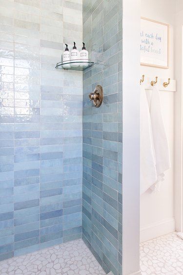 Blue Shower Tile Ideas and Inspiration | Hunker Seafoam Green Tile Bathroom, Bath Shower Combo Tile Ideas, Bathroom Tile Schemes, Scallop Shower Tile, Dave And Jenny Marrs Bathrooms, Blue Walk In Shower Ideas, Beachy Shower Tile Ideas, Blue Porcelain Tile Bathroom, Blue Zellige Bathroom