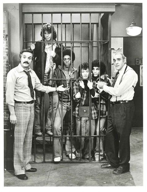 Hal Linden & Abe Vigoda of Barney Miller (1975-82) lock up "The Sweathogs" of Welcome Back, Kotter (1975-79): (left to right) John Travolta, Lawrence Hilton-Jacobs, Ron Palillo & Robert Hegyes. This sitcom-crossover was solely a publicity photo for ABC's Thursday night line-up, the casts never appeared together in an actual episode. Welcome Back Kotter, Barney Miller, 70s Tv Shows, Tv Icon, Tv Land, Classic Television, Old Shows, John Travolta, Old Tv Shows