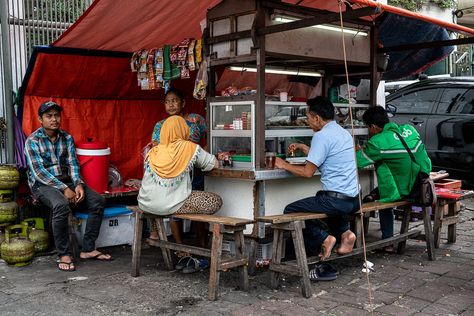 While walking down the wide street of Jakarta there was a food stall on the sidewalk. It... Read the rest on BOXMAN fotologue A photo shot in Jakarta Indonesia. Ramen Cart, Jakarta Street, Street Seller, Street Food Stall, Scene Reference, Street Photography Camera, Kota Tua, Long Bench, Street Vendor