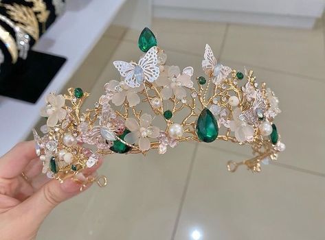 Enchanted Forest Crown Quince, Sweet 16 Party Ideas Themes Enchanted Forest, Emerald Green Wedding Tiara, Sweet 15 Dresses Quinceanera Green, Emerald Green Quince Tiara, Quinceanera Tiaras Emerald Green, Green Butterfly Decorations, Sage Green Quinceanera Dresses Long, Emerald Quinceanera Theme Tiara