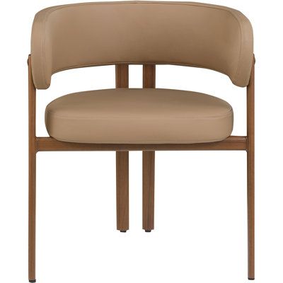 Elegant and eye-catching, the stunning faux leather Odab dining chair is the perfect addition to any space. Upholstery Color: Tan, Frame Color: Walnut | Hokku Designs Odab Unfinished Back Arm Chair Faux Leather / Upholstered in Brown | 28 H x 25 W x 21.5 D in | Wayfair Leather Dining Chair, Space Frame, Steak House, Chair White, Leather Dining Chairs, Arm Chair, Dining Chair, Brown Leather, Walnut