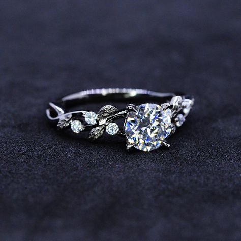 The default design option features 7mm Giliarto Moissanite Center Stone D - Color, SI1-Clarity, VG-Cut, Ex-Polish, VG-Symmetry and 0.2 TC Accents in 14K Black Gold Engagement Ring. Also you can fully customize and engrave this ring by clicking the button "Personalize in 3D". Model As well please remember it takes up to 19 days to make and ship this item. Engagement Rings Floral Band, Simple Floral Engagement Ring, Wedding Rings Engagement Floral, Silver Vine Engagement Ring, Dainty White Gold Engagement Ring, Engagement Rings Diamond And Sapphire, Leafy Engagement Ring, Wedding Ring Floral, Simple Dainty Wedding Rings