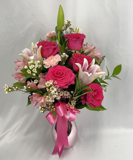 A beautiful collection of roses, lilies, carnations, alstroemerias, and wax flowers in pink tones. The vase may be substituted for a clear vase if pictured one is out of stock. Roses Flower Arrangements, Large Valentine Flower Arrangements, Flowers Arrangements For Mother’s Day, Pink And Red Rose Arrangement, Pink Lily Arrangement, Pink Rose Arrangements Vase, Flower Vase Gift, Seasonal Plants, Flower Arrangement Designs