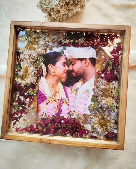 Sealing memories forever ♾️ 💕 My client Abhishek wanted to gift his friends our trending frames and placed order for 2 frames as a post-marriage gift 🎁 Upon receiving a beautiful fresh Lotus mala,we could able to dry them properly with utmost care & attention. To compliment the lotuses, added few bright rose petals & different sizes of pearls which enchanced the piece. And that's how the frame turned into 💕 I personally love how beautifully the floral shades got blended with the couple... Marriage Gifts For Couple In India, Resin Gift Ideas, Varmala Preservation, Marriage Gift, Wedding Garland, Marriage Gifts, Garland Wedding, Forever Me, Rose Petals