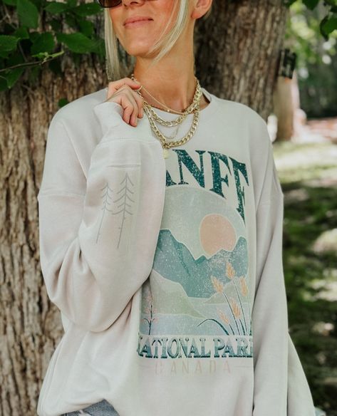 🌲 Exciting news! 🌲 Our amazing customers have been requesting new designs inspired by our breathtaking national parks, and we heard you loud and clear! 📢✨ We're thrilled to announce that our talented team has been hard at work designing these stunning pieces in-house. 🎨🏔️⁠ ⁠ 🗯️(Did we mention this #banffnationalpark design comes in a t-shirt AND sweatshirt with the super cute tree detail on the sleeve? & peep that BRAND NEW mineral wash tee #brycecanyon is printed on. #swoon )⁠ ⁠⁠ From the... National Park Sweatshirt, Outdoorsy Girl, Banff Canada, Target Customer, Colorful Sweatshirt, Summer Graphic Tee, Sweatshirt Oversized, Oversized Graphic Tee, Banff National Park