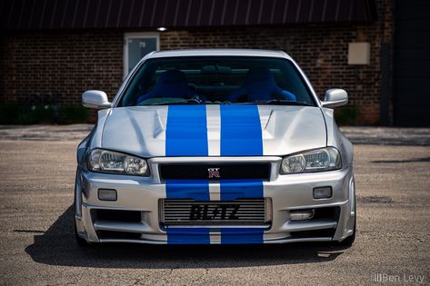 Front of Silver R34 Nissan Skyline GT-R with Blue Stripes - BenLevy.com Nissan R34, Car Evolution, Nissan Gtr R34, R34 Skyline, Skyline Gtr R34, R34 Gtr, Nissan Skyline Gt R, Gtr R34, Nissan Skyline Gt