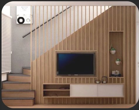 Stairs Tv Wall Living Rooms, Minimalist Living Room With Stairs, Small Living Room Ideas Under Stairs, Tv At Staircase, Tv Against Staircase, Under The Stairs Tv Unit, Tv Wall Design Stairs, Living Room Tv On Stair Wall, Tv Wall Ideas Living Room Under Stairs