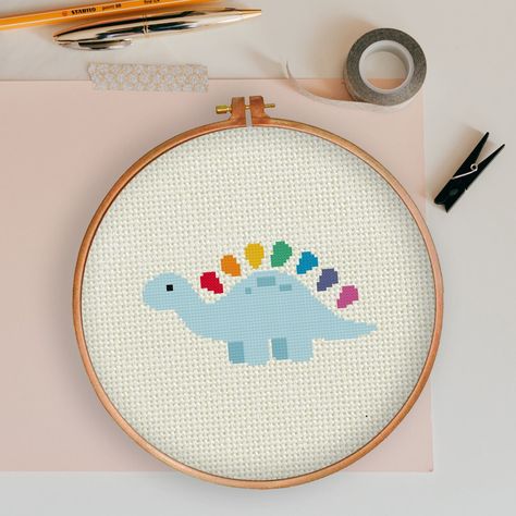 "INSTANT DOWNLOAD Rainbow Dino PDF Cross Stitch Pattern Needlecraft ----------------------------------------------------- Pattern: Fabric: 14 count Aida Stitches:  80W x 80H Size: 5.29\" x 2.79\" (74 x 39 stitches) 10 DMC Colors Use 2 strands of thread for cross stitch 2 PDFs Included 1 x Pattern in Color Blocks 1 x Pattern in Color Symbols ----------------------------------------------------- Instant Download Info: You will be emailed a link to the downloads via Etsy. Also, PDFs are available i Cross Stitch Modern Pattern, Dino Cross Stitch Pattern, Dinosaur Cross Stitch Pattern Free, Nursery Cross Stitch Patterns, Cross Stitch Patterns Cute, New Baby Cross Stitch, Cross Stitch For Baby, Cross Stitch Patterns Easy, Cute Cross Stitch Patterns