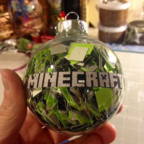 MINDCRAFT ORNAMENT- I cut up black, gray and green squares and put them inside a plastic ornament ( I got it at A c Moore - most craft stores carry them). I printed mind craft off of my computer, ran it thru my xyron sticker maker and adhered it to the front. My son and nephew are mind craft nuts - perfect Christmas present!!!! Diy Minecraft Ornaments, Minecraft Christmas Ornaments Diy, Minecraft Ornaments Diy, Minecraft Christmas Ornaments, Minecraft Ornaments, Minecraft Christmas Tree, Mind Craft, Diy Xmas Ornaments, Nerdy Christmas