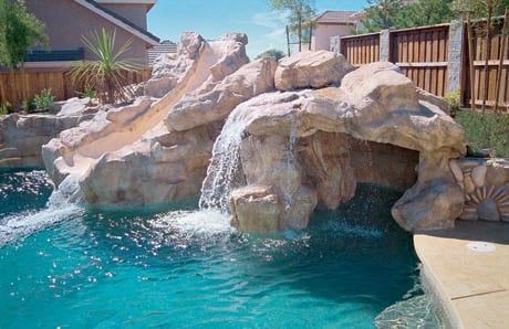 Ten affordable swimming pool grotto designs—in pictures—for your backyard Backyard Landscaping Ideas With Pool, Pool Rock Waterfall, Grotto Pool, Blue Haven Pools, Swimming Pool Waterfall, Swimming Pool Pictures, Swimming Pool Photos, Rock Waterfall, Custom Swimming Pool