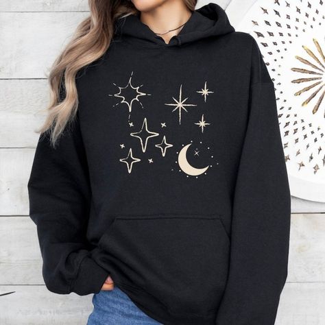 Available In Unisex S, M, L, Xl, And Xxl. Just Place An Order And Message Your Size After! Celestial Hoodie, Stars Sweatshirt, Cosmic Comfort Elevate Your Style With Our ""Celestial"" Hoodie! Made From Soft, Durable Fabric, This Hoodie Is Perfect For Stargazing Or Everyday Wear. It Features A Spacious Front Kangaroo Pocket, Adjustable Drawstring Hood, And Ribbed Cuffs For A Comfortable Fit. Whether You’re Out And About Or Relaxing At Home, This Hoodie Keeps You Cozy While Celebrating The Beauty Of The Cosmos. Material: 100% Cotton Made To Order With High-Quality Celestial Print. Moon Outfit Aesthetic, Space Inspired Outfits, Celestial Hoodie, Moon Clothes, Space Clothes, Moon Sweater, Celestial Print, Heart Icon, Fabric Waste