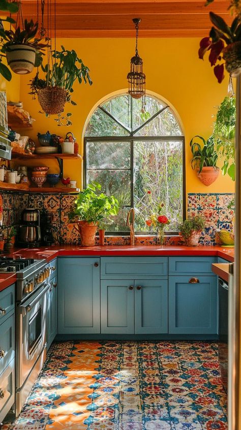 Bohemian kitchen with blue cabinets, colorful tiles, yellow walls, red accents, and hanging plants for a vibrant, cozy Boho Kitchen Design, Sage Green Cabinets, Earthy Kitchen, Boho Kitchen Ideas, Green Kitchen Designs, Whimsical Kitchen, Kitchen Bohemian, Green Kitchen Decor, Green Kitchens