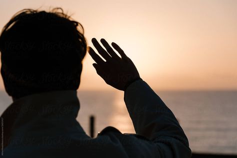 Silhouette of man hiding face from sun and looking at sky in sunset time. Back view of male holding hand up. Ocean before night time on background. Shielding Eyes From Sun Pose, Man Hiding Face, Sunset Photoshoot Ideas, Aesthetic Selfies, Hand Silhouette, Sunset Photoshoot, Sunset Time, Light Sun, Hiding Face