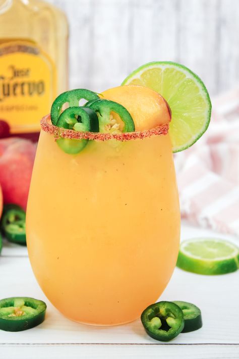 Our Spicy Peach Margarita blends peaches and a hint of spice with tequila, creating a refreshing, adventurous twist on the classic margarita. Spicy Peach Margarita, Spicy Peach Margarita Recipe, Melon Margarita Recipe, Spicy Blackberry Margarita, Peach Margarita Recipes, Blackberry Margarita, Spiced Peaches, Peach Margarita, Margarita Mix