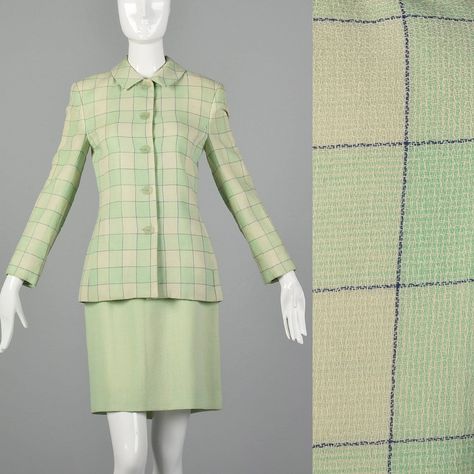 "This listing is for one skirt and one jacket. Textile is a mid weight 100% wool with crepe weave. Suit features windowpane plaid blazer with straight collar, long sleeves, and buttons up the front. Skirt is a solid light green color with straight silhouette, rear kick pleat, and rear zip closure. A fabulous spring or summer skirt suit! Condition Details: Excellent Condition. There is one small moth bite at the front of the blazer, but this is hard to find and this piece presents beautifully. Si Womens Power Suit, 60s Skirt, Vintage Fashion 1980s, 1980s Fashion Women, Vintage Skirt Suit, 1980s Women, Blazer And Skirt Set, 70s Inspired Fashion, Windowpane Plaid