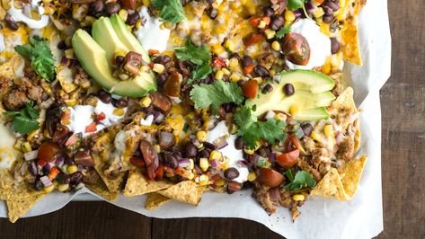 Supreme Venison Nachos Recipe | MeatEater Cook Venison Nachos, Avocado Sour Cream, Salsa Chili, Corn Bean Salsa, Tomato Snacks, Beef Nachos, Usa Beach, Crispy Chips, Nachos Beef