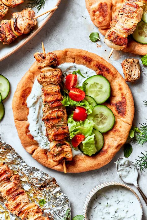 You don't need a trip to the Greek islands to enjoy Chicken Souvlaki! Tuck grilled, marinated chicken into soft pita bread and top it with tzatziki and fresh herbs for a Mediterranean-inspired meal you can whip up at home. Greek Chicken Souvlaki, Souvlaki Recipe, Chicken Souvlaki, Homemade Flatbread, Avocado Tomato Salad, Greek Seasoning, Greek Flavors, Greek Cooking, Creamed Spinach