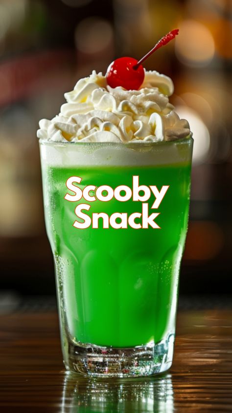 This creamy, fruity drink is perfect for sipping on a warm evening or at a festive gathering with friends. It combines the smooth flavors of coconut rum, crème de bananas, and melon liqueur with a splash of pineapple juice and a generous dollop of whipped cream for a truly delightful treat. #scoobysnackcocktail via @mybartender Scooby Snack Drink, Scooby Snack Cocktail, Midori Cocktails, Green Cocktails, Melon Liqueur, Colorful Drinks, Cocktails To Try, Yummy Alcoholic Drinks, Fruity Cocktails