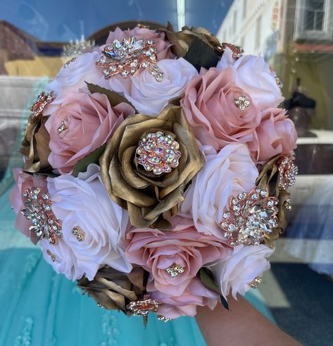 Handmade quinceañera bouquet with dusty blush, ivory and gold color shade of roses. Finished off with RoseGold brooches. *Please note brooches can change in style based on availability*   Decor can be changed upon request.  *This is a made to order bouquet* Gold Quinceanera Bouquet, Rosa Golden, Satin Flowers Diy, Royal Blue Quinceanera, Ribbon Rose Bouquets, Quinceanera Bouquet, Dress Bustle, Pink Quince, Wedding Dress Bustle