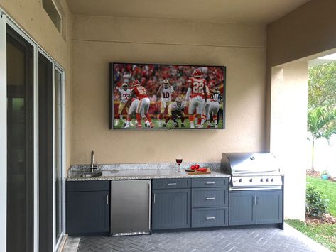 Outdoor Kitchen with Shaker Cabinet Doors | Custom Design Tampa Outdoor Kitchen With Tv Wall, Luna Pearl Granite Countertops, Kitchen Doors Ideas, Outdoor Kitchen Island Ideas, Pearl Granite Countertops, Luna Pearl Granite, Patio Tv, Patio Upgrade, Shaker Cabinet Doors