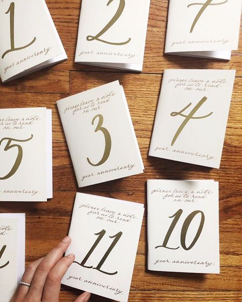 Michigan Calligrapher / Angela on Instagram: “Table numbers that double as anniversary keepsake journals— how FUN will these be to crack open each year?! 🥂📙 Congratulations M+P!…” Table Number Booklet, Wedding Table Anniversary Notes, Books As Table Numbers, Wedding Table Anniversary Cards, Fun Table Number Ideas, Fun Table Numbers, Diy Table Numbers Wedding, Calligraphy Numbers, Wedding Table Number Ideas