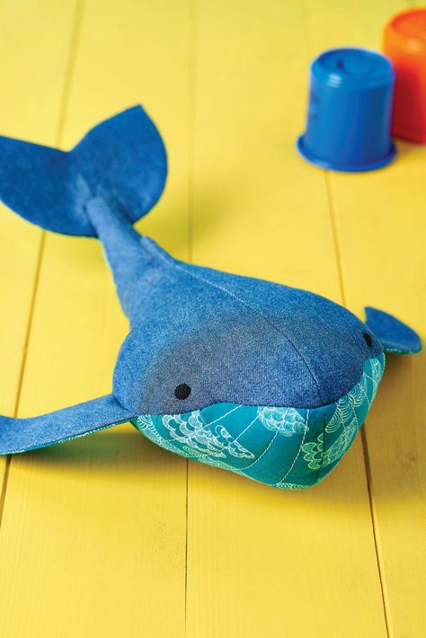 This friendly whale by Cheryl Owen is the perfect companion and proves a great way to recycle old jeans. Choose a bright contrast fabric for the belly and underside of the fins and tail. You’ll be riding the waves in no time! Whale Plushie Pattern, Sewing Animals, Felt Turtle, Whale Stuffed Animal, Sewing Cushions, Soft Toy Patterns, Animal Sewing Patterns, Sewing Magazines, Sewing Stuffed Animals