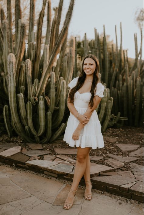 senior pictures with cactus in the background in phoenix arizona at the desert botanical gardens Desert Botanical Garden Arizona Photoshoot, Cactus Senior Pictures, Desert Photoshoot Poses, Mexico Senior Pictures, Desert Botanical Garden Photoshoot, Senior Pictures In Arizona, Desert Grad Photos, Senior Pictures Desert, Graduation Pictures Desert