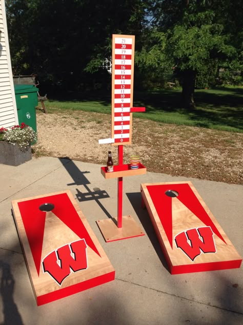 Cornhole: Wisconsin Badgers-themed cornhole set. Includes scoring tower with integrated drink holder and bottle opener. Not shown is a second free-standing drink holder. Holes are illuminated with LED light rings sold online specifically for cornhole boards. Maple construction. Corn Hole Score Board Diy, Cornhole Scoreboard, Diy Cornhole, Diy Cornhole Boards, Diy Yard Games, Corn Hole Diy, Cornhole Designs, Cornhole Game, Cornhole Board