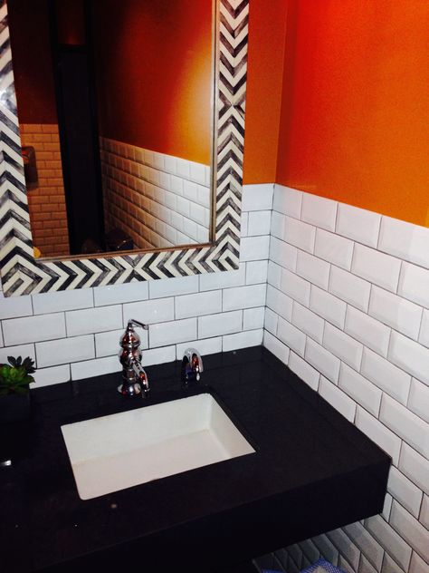 White subway tile with orange accent wall and black bathroom counter Black White And Orange Bathroom, Black And Orange Bathroom, Orange And Black Bathroom, Black Bathroom Counter, Orange Tile Bathroom, Hexagon Tile Kitchen Floor, Subway Tile Ideas, Groovy House, Mod Bathroom