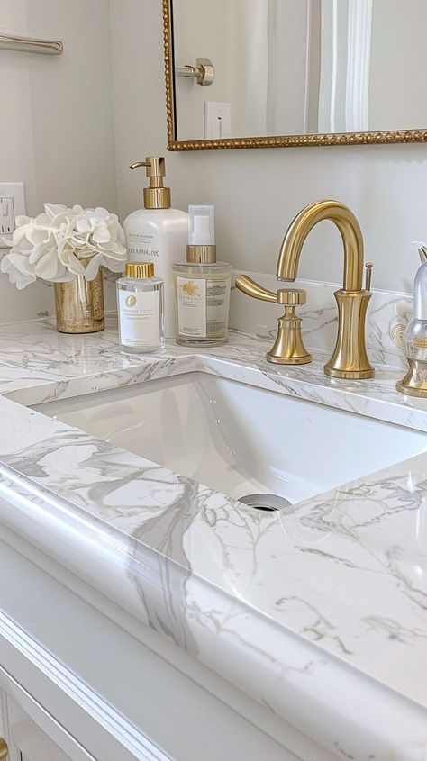 Elegant white marble bathroom countertop with golden fixtures and accessories, creating a sophisticated and luxurious atmosphere. Marble Bathroom Countertop, Golden Bathroom, White Marble Bathroom, White Marble Bathrooms, Dream Life House, Room Aesthetics, White Marble Countertops, Bathroom Countertop, Marble Countertop