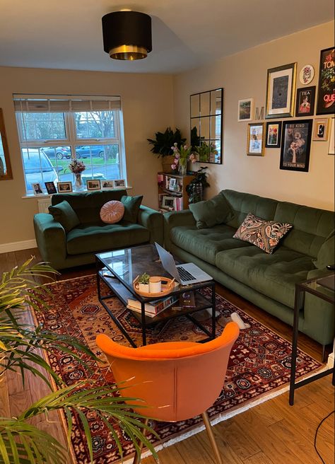 Gallery wall, green sofa, orange rug living room Orange And Green Apartment Decor, Orange Rug Green Couch, Real People Real Rooms, Apartment Decor Green Couch, Living Room Decor Artsy, Green Couch Cozy Living Room, Living Room Green Couch Decor, Living Room With Lots Of Doorways, Homey House Interior Living Room