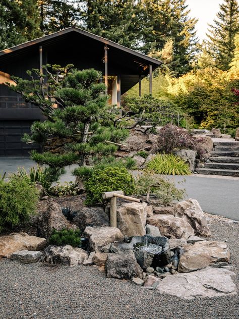 A Japanese-style Bamboo water fountain sits in the driveway. Tagged: Outdoor, Boulders, Trees, Front Yard, Walkways, Hardscapes, and Garden. Photo 11 of 15 in Nearly 80 Years Later, an Architect Rescues a Japanese-Inspired Masterwork Designed by His Father Japanese Garden Island, Japanese Driveway, Front Yard Walkways, Driveway Fountain, Trees Front Yard, Japandi Outdoor, Japanese Fountain, Bamboo Water Fountain, Garden Bonsai Tree