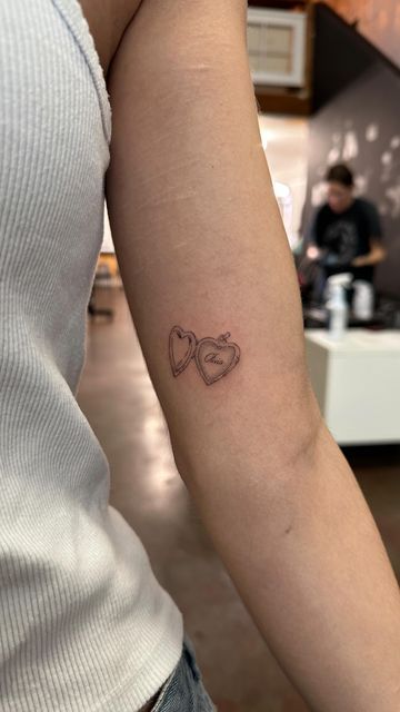 Sam’s Tattoos on Instagram: "a couple of lil locket tattoos" Locket Tattoo Placement, Heart Locket Tattoo Simple, Locket Tattoo With Initials, Locket Initial Tattoo, Love Letter Tattoo Envelope, Upper Arm Tattoo Placement, Tattoos About Mom, Valentines Tattoo, Love Letter Tattoo