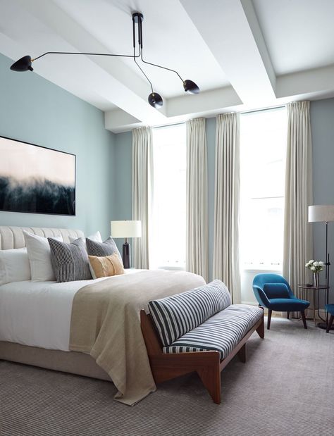 “We struck a balance between making the space feel masculine, while still giving it the ability to appeal to a woman,” notes Sanders of the master bedroom. The walls are bathed in Pale Powder by Farrow & Ball; a bed from Consort cozies up to a bench from Sabin. Over the bed hangs a dreamy art piece by Brian Merriam. Serge Mouille Ceiling Lamp, Bachelor Pad Decor, Eclectic Bedroom, Bachelor Pad, Bedroom Paint Colors, New York Apartment, Design Del Prodotto, Bedroom Paint, Decor Minimalist