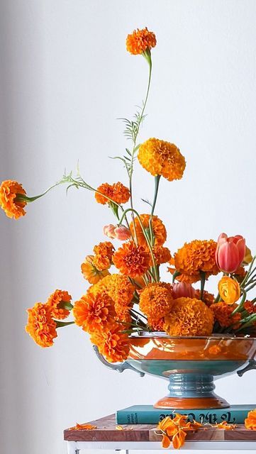 B L U E J A S M I N E on Instagram: "Local marigolds make friends with minty hard goods…. A somewhat unusual pairing but feels so right - like that perfect salty and sweet treat. 🍊👗 Pin frog @floralgeniusig | candles @yummicandles | blooms @gardenstateflowercoop … #njflorist #njflowers #florist #dslflowers #fineartflowers #floweraddict #moodforfloral #playingwithpetals #floralstories #petalsandprops #flowers #floraldesigner #floraldesign #weddingstyle #flowerpower #floristlife #florallove Marigold Flowers Wedding, Marigold Floral Arrangement, Marigold Boutonniere, Marigold Flower Arrangements, Marigold Arrangements, Day Of The Dead Marigolds, Marigold Wedding Flowers, Marigold Centerpiece, Unusual Flower Arrangements