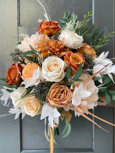 "burnt orange & ivory white fall bouquet, wedding bouquet, fall wedding bouquet, fall wedding bouquet for bride or bridesmaids, fall rustic bouquet Introducing our stunning wedding bouquet, a perfect floral accessory to make your special day truly unforgettable. Expertly handcrafted with love, this bouquet features an exquisite collection of blossoms carefully selected for their elegance and beauty. Delicate roses, fragrant lilies, and dainty daisies effortlessly come together, creating a romantic blend of colors and textures. Whether you're dreaming of a boho chic or a classic fairytale wedding, this bouquet will effortlessly elevate your bridal ensemble and perfectly complement your theme. Radiate sophistication and grace as you gracefully walk down the aisle with our enchanting wedding White Fall Bouquet Wedding, Fall Bridesmaid Bouquets, February Bouquet, Fall Bouquet Wedding, Wedding Bouquet Fall, Bouquet For Bride, Bouquet Fall Wedding, Orange Wedding Bouquet, Wedding Motif