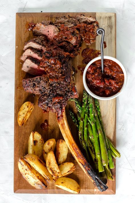 Learn how to grill the perfect tomahawk ribeye steak. Serve this impressive cut of meat with Spicy Barbecue Relish, grilled asparagus, and potato wedges for a meal everyone will love! #tomahawksteak #recipe #ribeye #howtogrill Western Foods, Tomahawk Ribeye, Restaurant Steak, Tomahawk Steak, Grilled Steak Recipes, Steak Frites, Grilled Asparagus, Potato Wedges, Steak Dinner