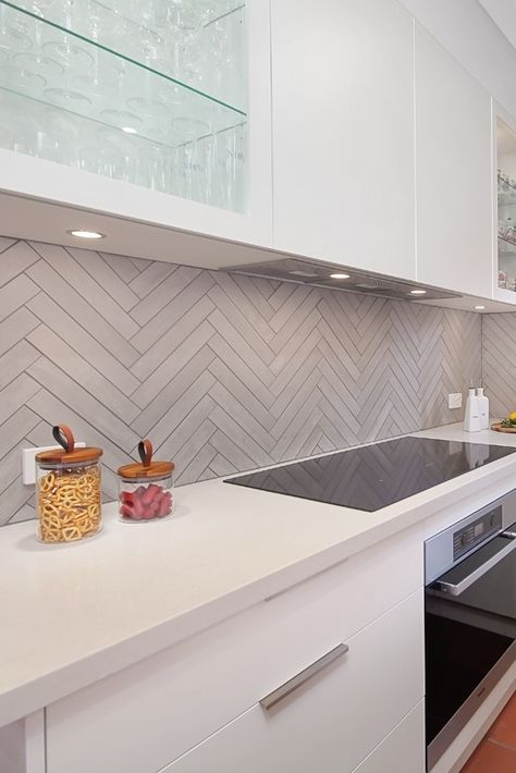 Beware of the splash 🍳 🍳 🍳 Tile splashback is a great solution. Wonderfully hardwearing. They are easy to clean and can be cost-efficient, depending on what tile and layout you choose. Herringbone has been with us since the 16th century and is a great option for creating a strong focal point. Suits both traditional and modern kitchens. We 🧡 this tiled splashback. Classic herringbone, using grey modern textured tile. #tiles #splashback #herringbone #kitchendesign #interiordesign Grey Kitchen Tile Ideas, Herringbone Tile Splashback Kitchen, Herringbone Kitchen Tile Backsplash, Kitchen Tiles Backsplash Grey Cabinets, Simple Kitchen Splashback, Feature Wall Kitchen Ideas, Kitchen Tile Splashback Ideas, Modern Kitchen Tiles Wall, Grey Tile Splashback Kitchen