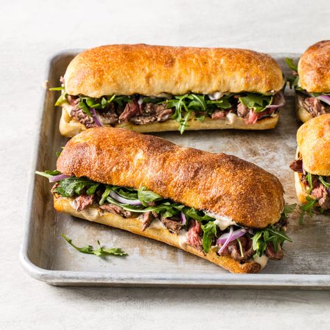 Tender meat, a bold blue cheese sauce, and peppery arugula define this classic lunch. Blue Collar Lunch Ideas, Gordon Ramsay Steak, Steak Sandwich Recipes, Steak Sandwiches, Blue Cheese Sauce, Rustic Recipes, Tender Meat, America's Test Kitchen Recipes, Steak Sandwich