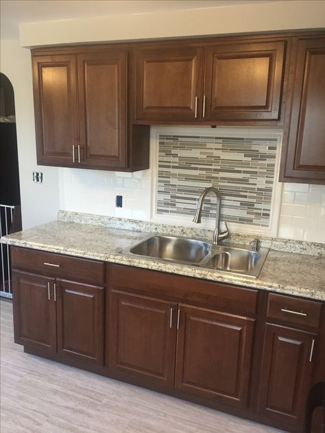 Hampton Bay cognac kitchen cabinets with subway tile backsplash and mosaic accent medallion. Cognac Kitchen Cabinets, Hampton Bay Kitchen Cabinets, Kitchen Cabinets Dimensions, Best Countertops, Apartment Remodel, Marble Backsplash Kitchen, Kitchen Cabinet Accessories, Kitchen Cabinets Pictures, Diy Kitchens