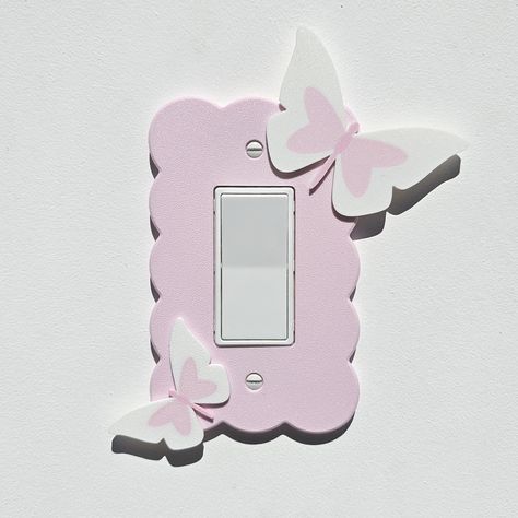 This listing is for a custom single pink cloud design light switch plate cover with pastel white and pink butterfly design. This listing fits a double rocker switch but is available for single, double and triple rocker switch cover plates.  Perfect for toddlers room, kids room, nursery or anywhere a little creativity or brightness is wanted. Great for Baby Shower Gift, Birthday Gift or when remodeling.  Designed with pastel colors and a textured finish which shimmers in the light. Easy to instal Coquette Light Switch Cover, Pastel Pink Butterfly, Toddlers Room, Cloud Light, Pastel White, Butterfly Nursery, Baby Room Themes, Cloud Design, Cloud Lights