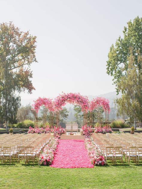 We're entering the year of the pink wedding — we’re talking bright pink color palettes, lush pink florals, and perfectly-pink photo ops — but with an elevated twist. Discover 21 stunning pink wedding ideas for your celebration. Pink Marriage, Wedding Venues Pink, Pink Destination Wedding, Pink Wedding Arch, Light Pink Tropical Wedding, Pink Wedding Ceremony, Rani Pink Decor Wedding, Pink Theme Wedding, Pink Color Palettes